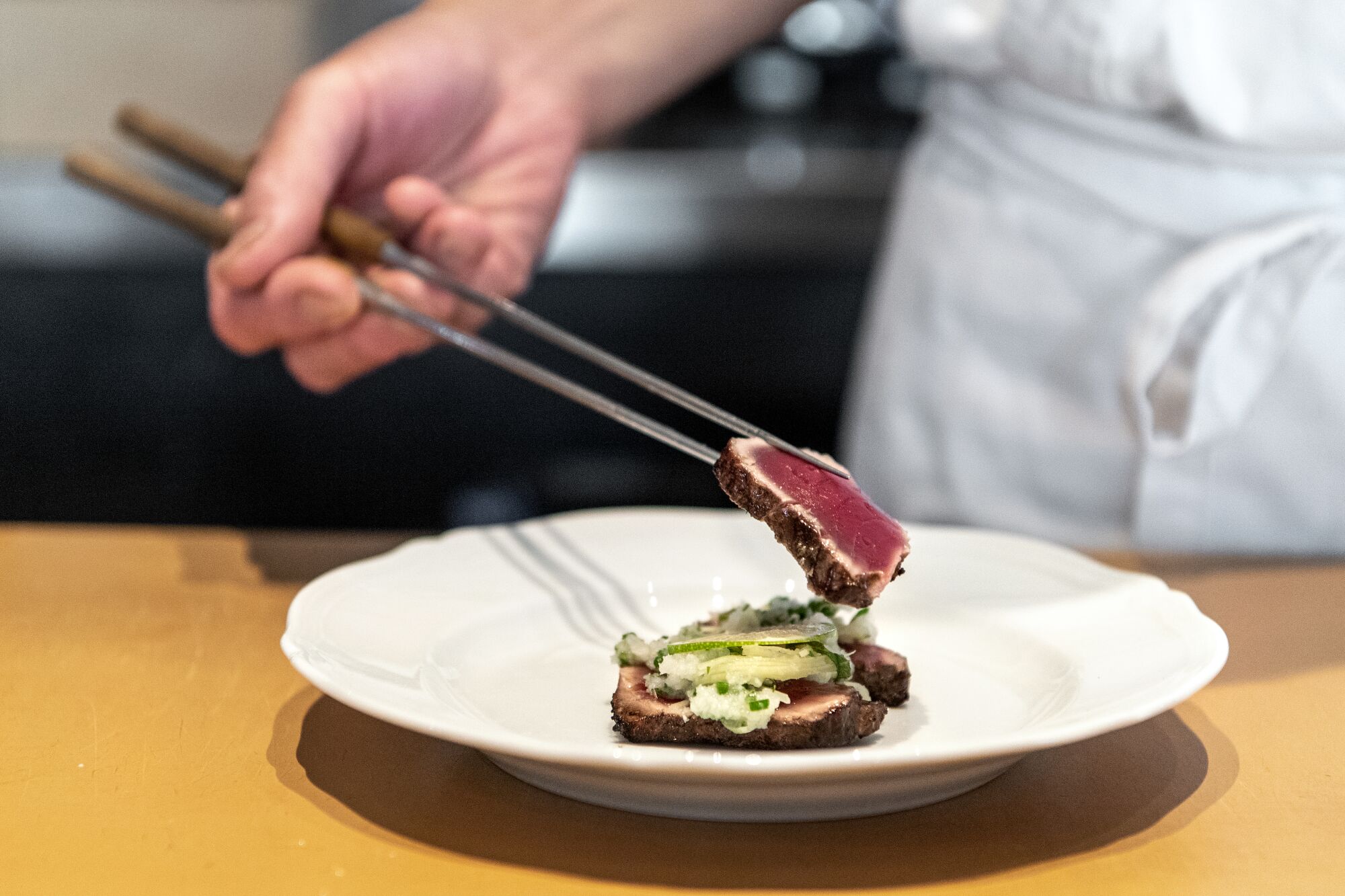 Chef Junya Yamasak prepares the blue fin tuna sashimi at Yess Aquatic restaurant.