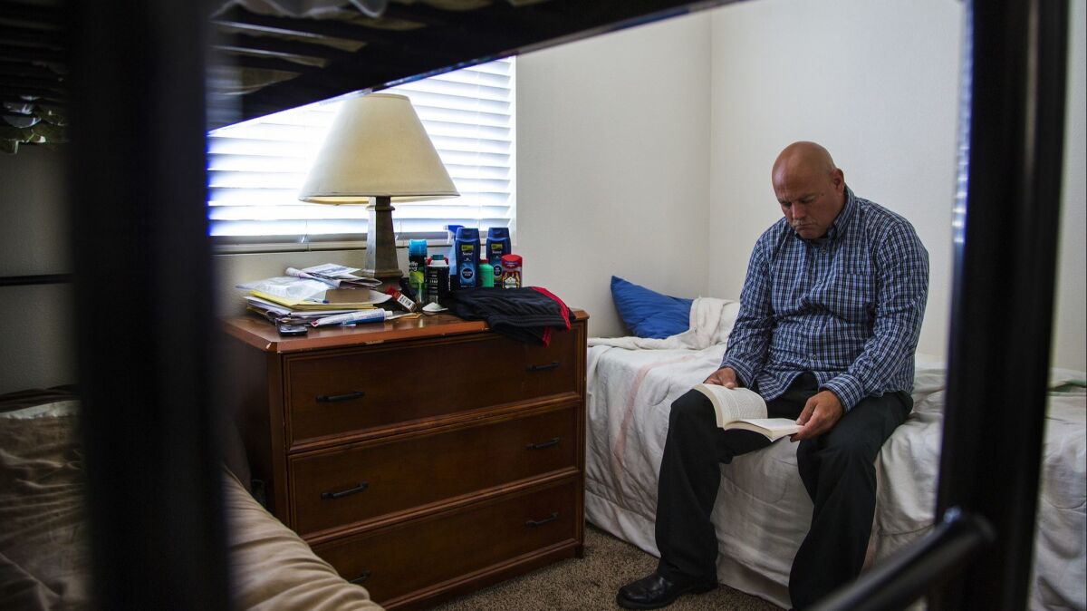 Michael Brown, 46, spends time in 2016 reading in his room at a house in Hesperia for nonviolent felons who are homeless when they are released from jail. The house and others like it are run by a nonprofit that challenged the city's housing rules in federal court.