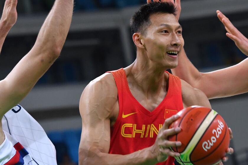 Yi Jianlian runs with the ball during a men's round Group A basketball match between Serbia and China during the 2016 Rio Olympics on Aug. 14.