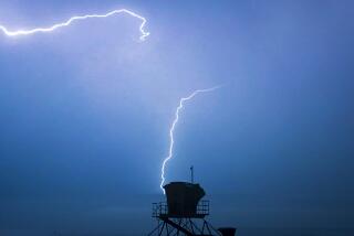 Huntington State Beach lifeguard tower is silhouetted by a lightning strike as a monsoonal storm bringing thunder, lighting and rain moved in to the southland early Wednesday, August 11, 2021 at Huntington State Beach, Huntington Beach.