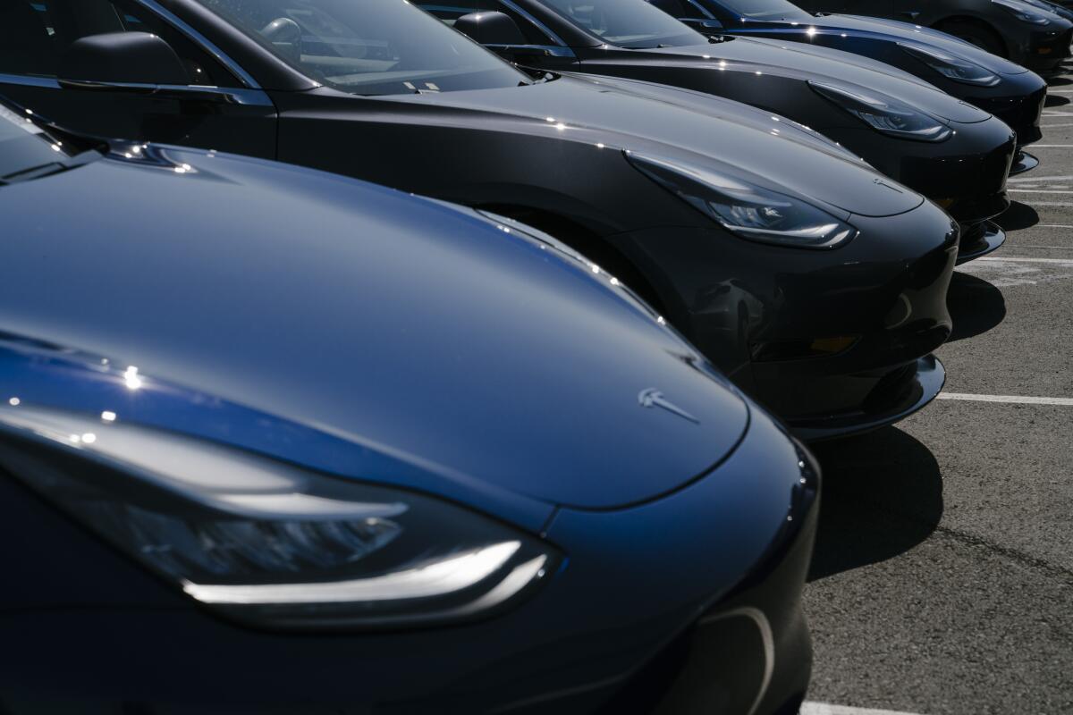 Tesla vehicles are lined up outside the carmaker's factory in Fremont, Calif.