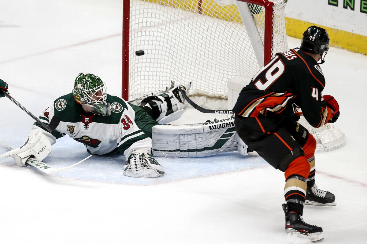 The Ducks' Max Jones misses a shot as Minnesota Wild goalie Kaapo Kahkonen defends in the third period Feb. 20, 2021.