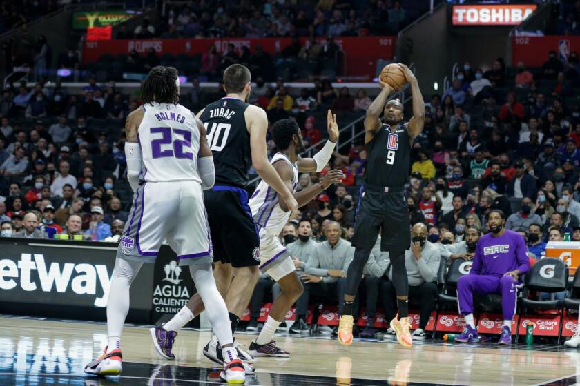 LOS ANGELES, CA - DECEMBER 01: Los Angeles Clippers center Serge Ibaka attempts a shot against a Kings player at the Staples Center on Wednesday, Dec. 1, 2021 in Los Angeles, CA. (Jason Armond / Los Angeles Times)