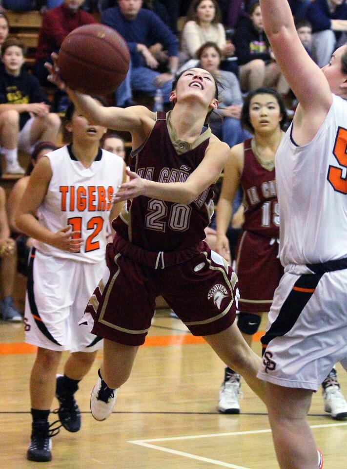 La Canada's Courtney Chen falls forward to shoot and score against South Pasadena in a Rio Hondo League girls basketball game at South Pasadena on Friday, January 31, 2014.