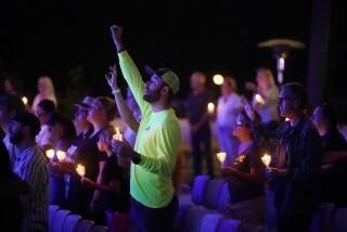 People attend a prayer vigil Friday, Aug. 25, 2023, in Lake Forest, Calif., for victims of the shootings Wednesday at Cook's Corner in Trabuco Canyon. (AP Photo/Damian Dovarganes)