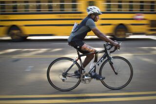 Emmanuel Ofosu Yeboah, preparing for a ride early next month to Oregon, trains along Friars Road in Mission Valley.