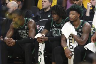 Boston Celtics' Jaylen Brown, from left, sits on the bench with Robert Williams III and Marcus Smart during the second half of Game 5 of basketball's NBA Finals against the Golden State Warriors in San Francisco, Monday, June 13, 2022. (AP Photo/Jed Jacobsohn)