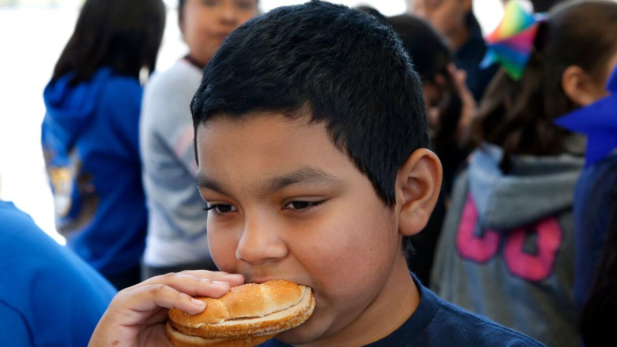 Entrees such as an oven-roasted turkey breast sandwich, consumed by Marco Felix at Belvedere Elementary School, filled in for chicken after a dispute between L.A. Unified and major chicken producers.