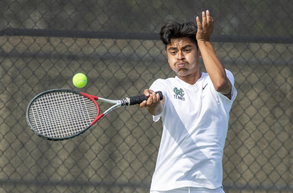Costa Mesa's Raoul Hernandez returns a forehand during a Battle for the Bell match at Costa Mesa High School on Tuesday.