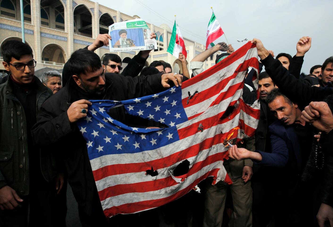Iranians burn a U.S. flag during a protest in Tehran to condemn Suleimani's killing.