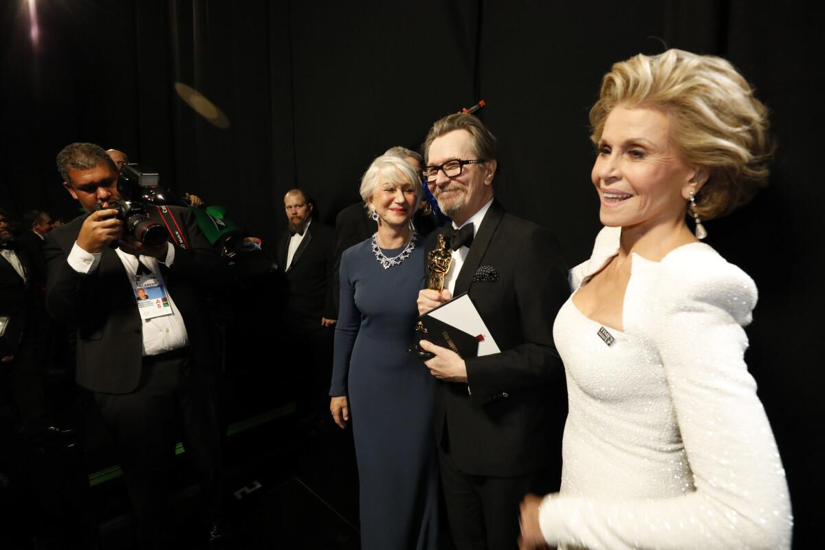 Gary Oldman, after winning the lead actor Oscar for "The Darkest Hour," backstage with Helen Mirren, left, and Jane Fonda at the 90th Academy Awards.