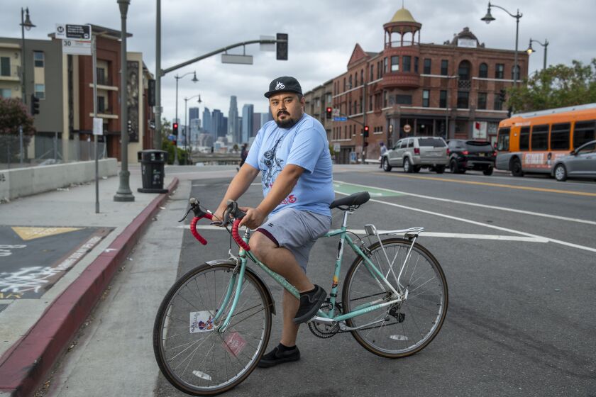 BOYLE HEIGHTS, CA - AUGUST 18, 2021: Erick Huerta, 37, who has been stopped by sheriff's deputies while riding his hybrid road bike, is photographed on 1st St. in Boyle Heights. (Mel Melcon / Los Angeles Times)