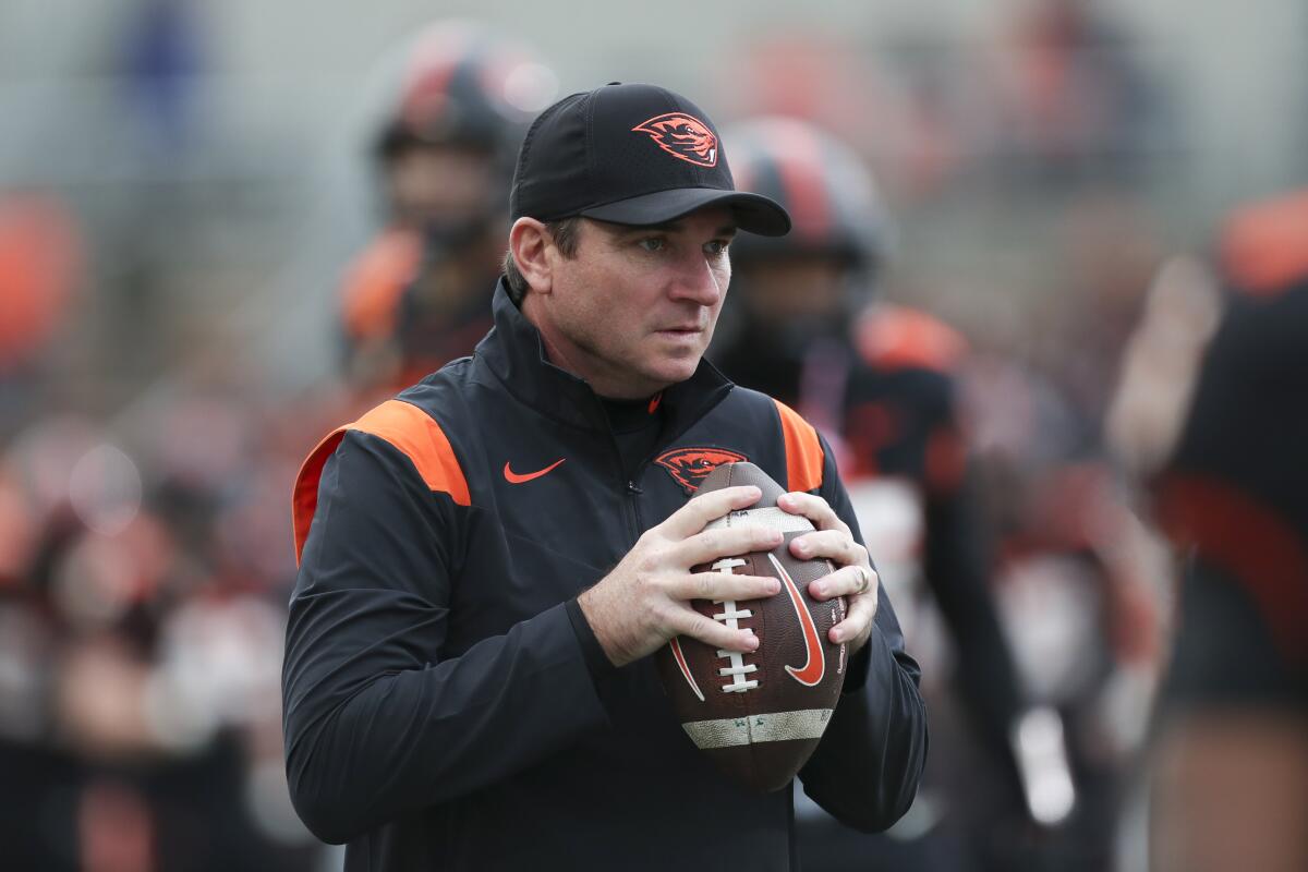 Oregon State coach Jonathan Smith holds a football before a game against Colorado on Oct. 22.