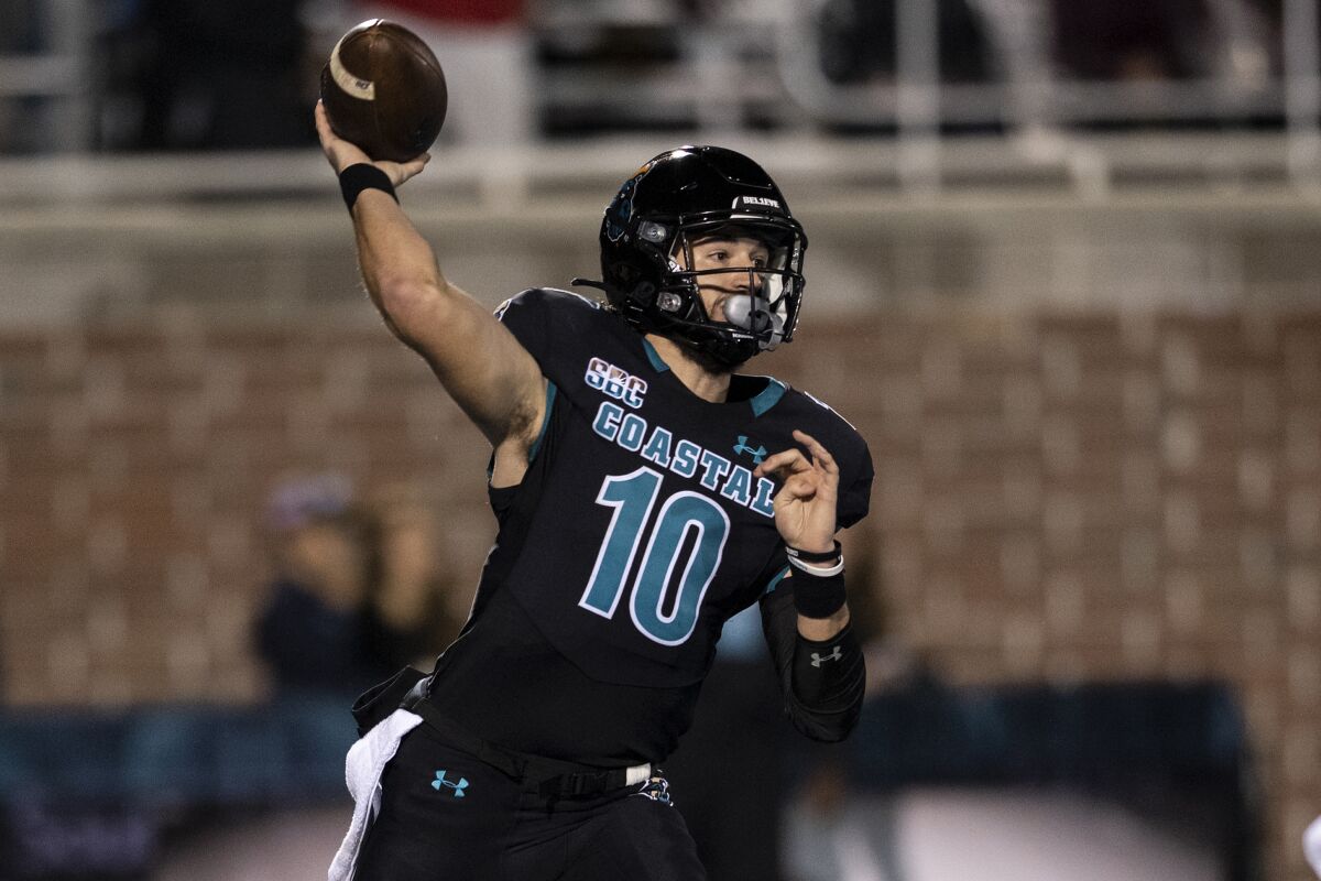 Coastal Carolina quarterback Grayson McCall throws a pass during the first half of the team's NCAA college football game against Troy on Thursday, Oct. 28, 2021, in Conway, S.C. (AP Photo/Matt Kelley)