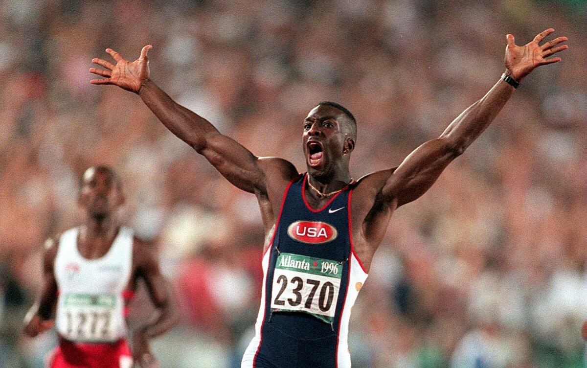 Michael Johnson reacts after crossing the finish line and winning the gold medal in the men's 200 meters.