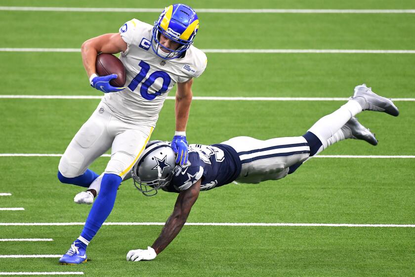 INGLEWOOD, CALIFORNIA SEPTEMBER 13, 2020-Rams receiver Cooper Kuppis tackled by Cowboys cornerback Anthony Brown after a reception in the 1st quarter at SoFi Stadium in Inglewood Sunday. (Los Angeles Times/Wally Skalij)