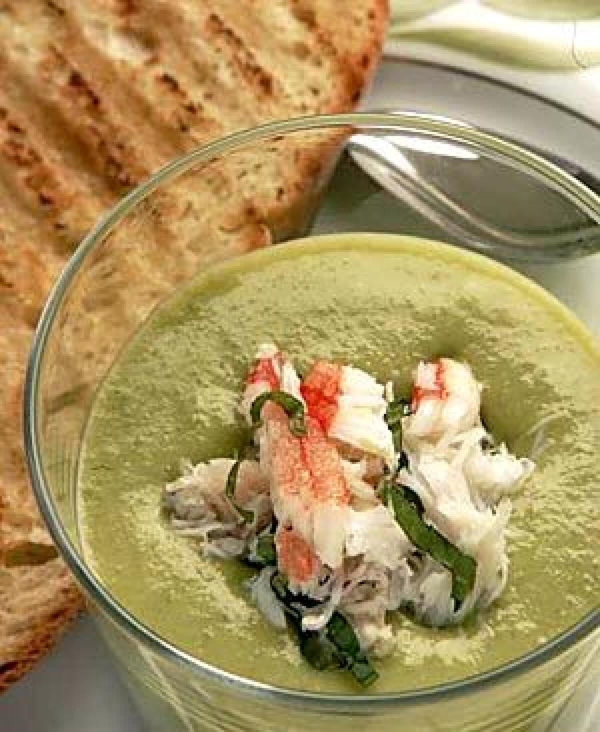 A silky chilled bisque of English peas is topped with crab and slivers of fresh mint.