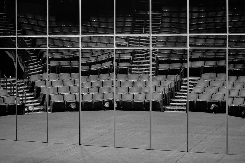 Empty seats at the Mark Taper Forum are reflected in a mirror.