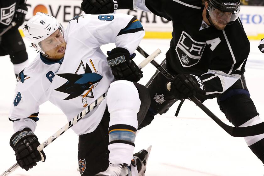 Anze Kopitar, right, battles with San Jose's Joe Pavelski for a loose puck during the first period of Game 4 at Staples Center.