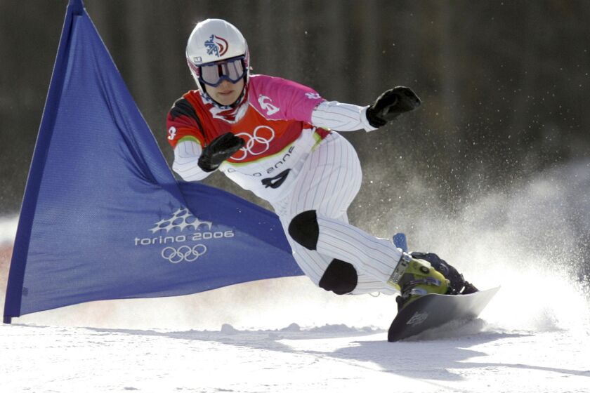 FILE - United States Rosey Fletcher clears a gate during the women's snowboard parallel giant slalom race at the Turin 2006 Winter Olympic Games in Bardonecchia, Italy, on Feb. 23, 2006. Olympic bronze medalist Rosey Fletcher filed a lawsuit accusing former snowboard coach Peter Foley of sexually assaulting, harassing and intimidating members of his team for years, while the organizations overseeing the team did nothing to stop it. Fletcher is a plaintiff in one of two lawsuits filed in U.S. District Court in Los Angeles on Thursday, Feb. 2, 2023. (AP Photo/Charles Krupa, File)