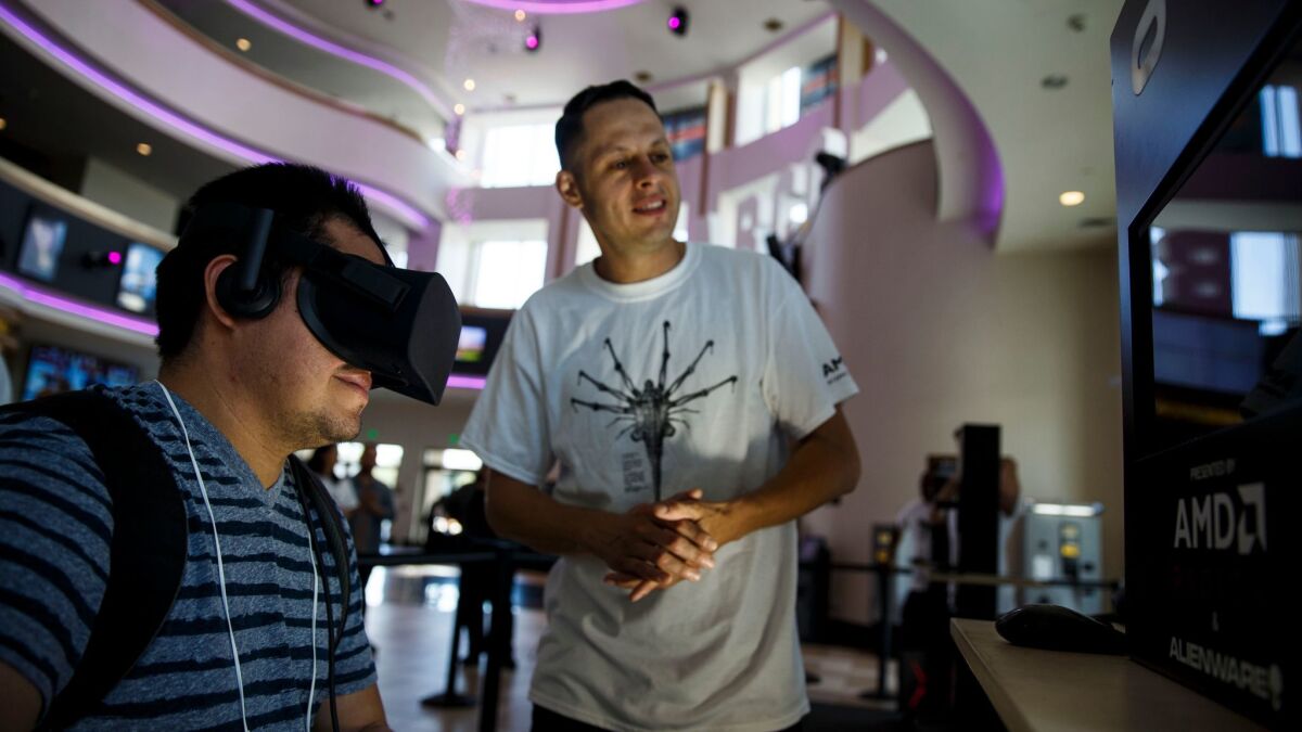 Williams Avelar tries virtual reality at Regal L.A. Live. (Patrick T. Fallon / For The Times)