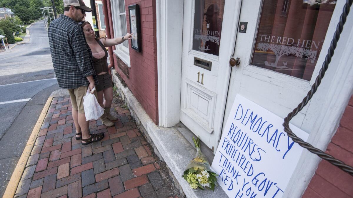 Passersby examine the menu Saturday at the Red Hen in Lexington, Va.