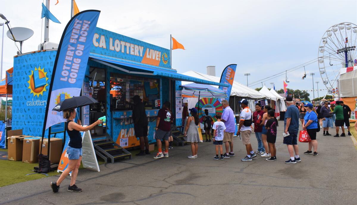 Orange County fairgoers line up to buy lottery tickets at a booth Thursday, August 1, 2024. 