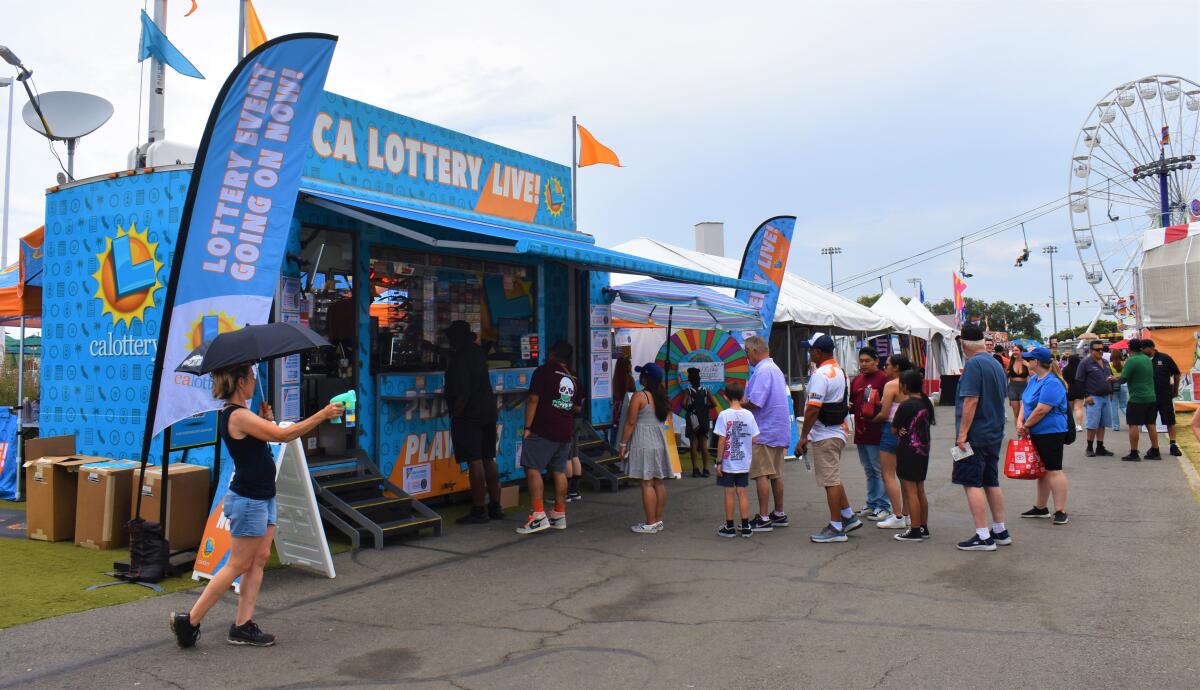 Orange County fairgoers line up to buy lottery tickets at a booth Thursday, August 1, 2024.
