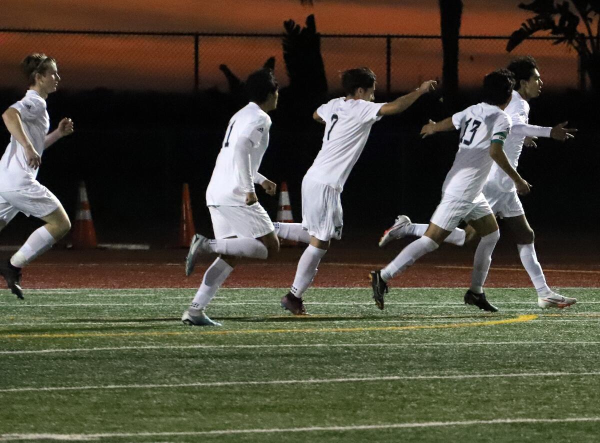 The Costa Mesa boys' soccer team celebrates after scoring a goal against Estancia in the Battle for the Bell on Friday.