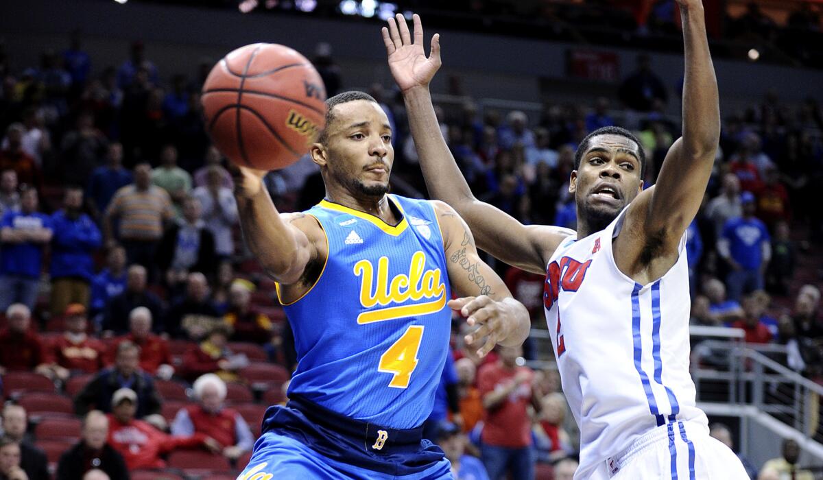 Guard Norman Powell, passing against SMU center Yanick Moreira on Thursday, is one of many Bruins basketball players who are glad their quarterly final exams are completed.