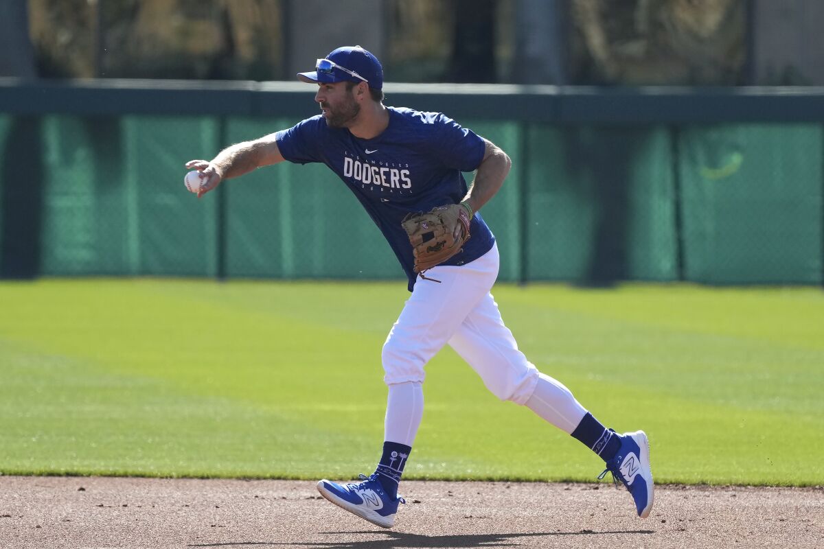 Chris Taylor tosses a ball to second base.