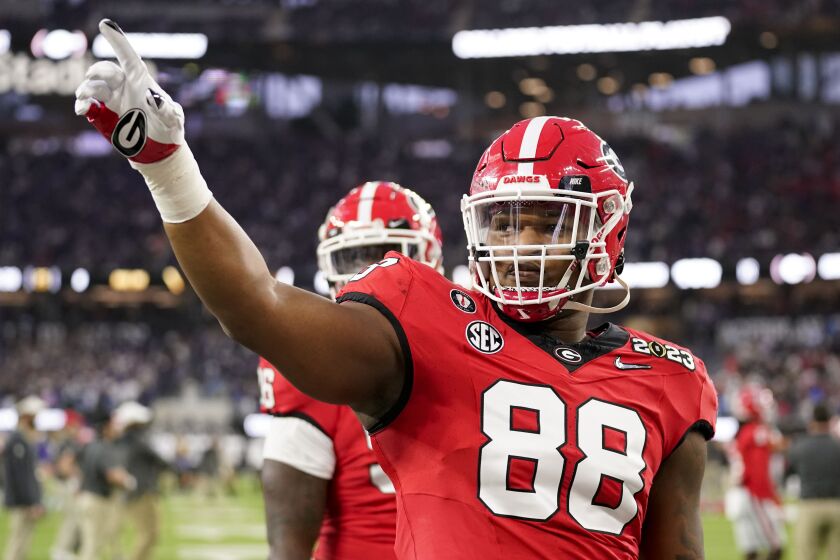 Georgia defensive lineman Jalen Carter (88) waves to the crowd before the national championship NCAA College Football Playoff game between Georgia and TCU, Monday, Jan. 9, 2023, in Inglewood, Calif. (AP Photo/Ashley Landis)