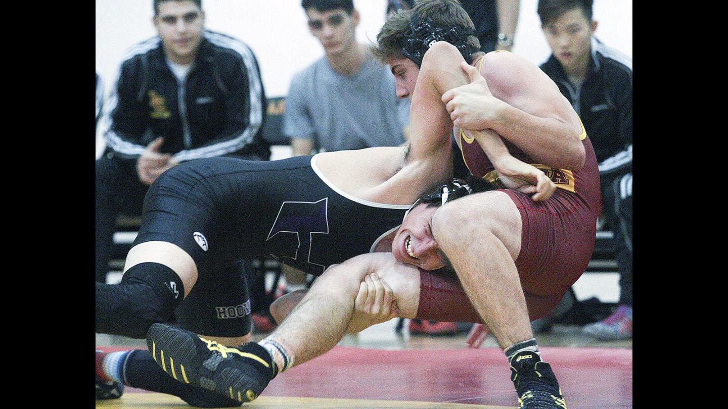 Hoover's Michael Fernandez drives La Cañada's Ben Donaho to the matt and out of bounds in a Rio Hondo League wrestling match at La Cañada High School High School on Thursday, January 21, 2016. Hoover won the match, the first time in school history.