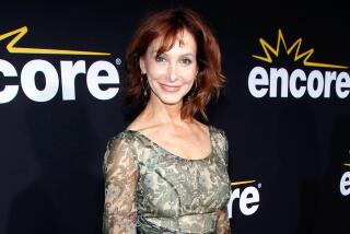Jill Jacobson in a sheer green dress smiling and posing against a black background with white text