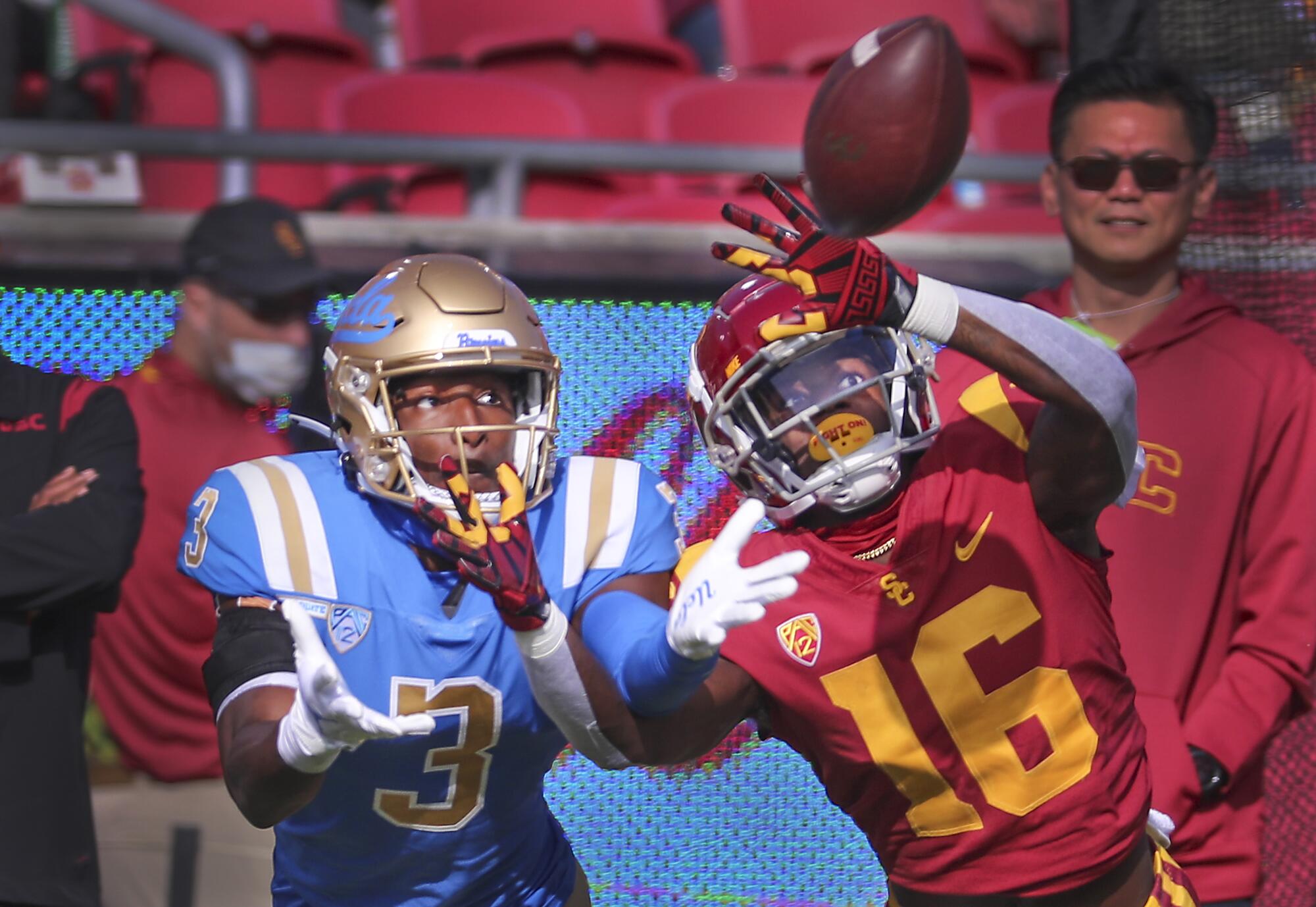 USC wide receiver and UCLA defender battle for a pass.