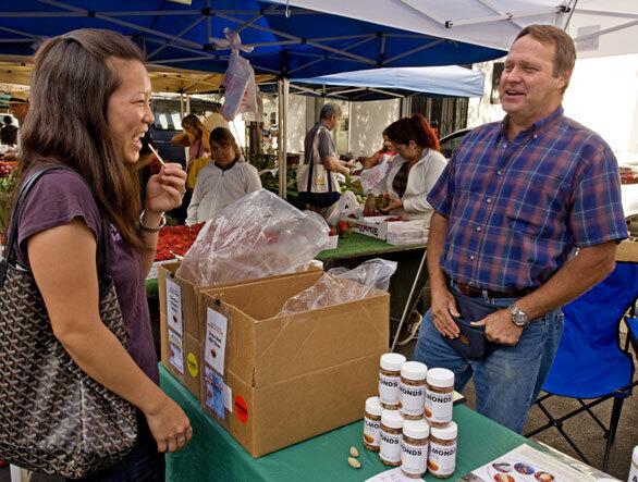 George Yemetz, of Yemetz Family Orchards in Madera County, sells unpasteurized organic Carmel and Nonpareil almonds at the Hollywood Farmers Market.