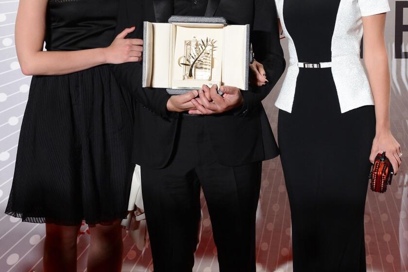 Actress Mona Walravens, left, director Abdellatif Kechiche and actress Lea Seydoux, winner of the Palme d'Or for "La Vie D'adele" ("Blue Is the Warmest Color"), attend the Palme D'Or Winners dinner.