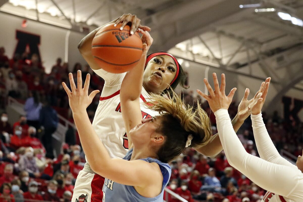 North Carolina State's Jada Boyd, top, rejects a shot by North Carolina's Eva Hodgson, bottom left, during the first half of an NCAA college basketball game, Thursday, Jan. 6, 2022, in Raleigh, N.C. (AP Photo/Karl B. DeBlaker)
