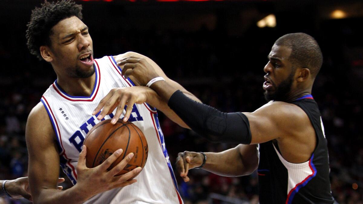 76ers center Jahlil Okafor battles for a rebound with Clippers guard Chris Paul during a game Feb. 8 in Philadelphia.