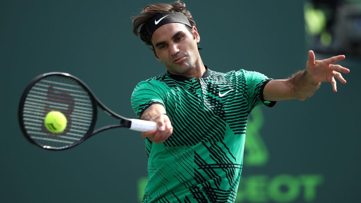 Roger Federer returns a shot against Tomas Berdych during their quarterfinal match at the Miami Open on Thursday.