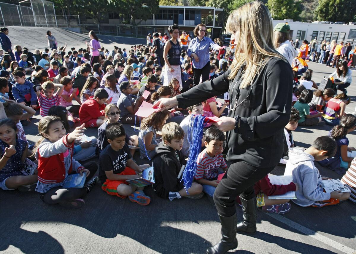 Glenoaks Elementary School 4th teacher Chrissandra Sparks passes out name tags to her students during the Shakeout event at the Glendale school on Thursday, Oct. 17, 2013. The school, with 24 classes and 550 children, participated in a world-wide annual earthquake drill.