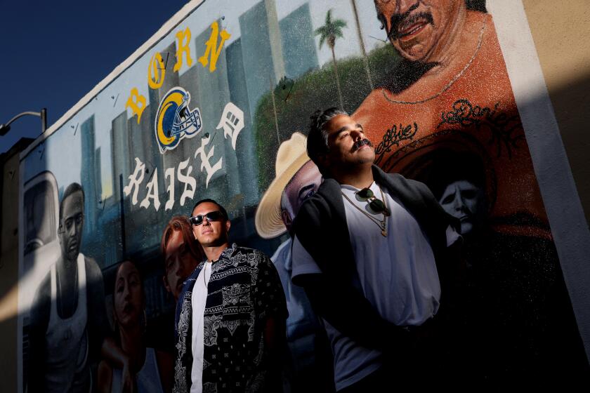 LOS ANGELES, CA - JUNE 17: Spanto, left, and Alex/2Tone, founders of the L.A. Based brand Born X Raised, pose in front of a mural by artist Alfonso Gonzalez Jr. in East Los Angeles, on Wednesday, June 17, 2020 in Los Angeles, CA. They recently did a hoodie/tee collaboration with the L.A. Rams. (Gary Coronado / Los Angeles Times)