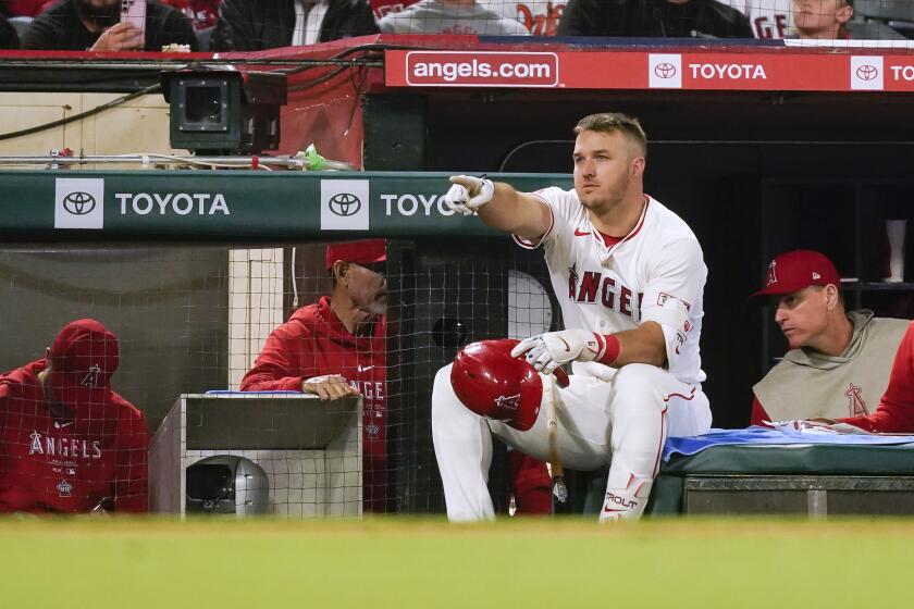 Los Angeles Angels' Mike Trout gestures while waiting to bat during the sixth inning of the team's baseball game against the Baltimore Orioles, Tuesday, April 23, 2024, in Anaheim, Calif. (AP Photo/Ryan Sun)
