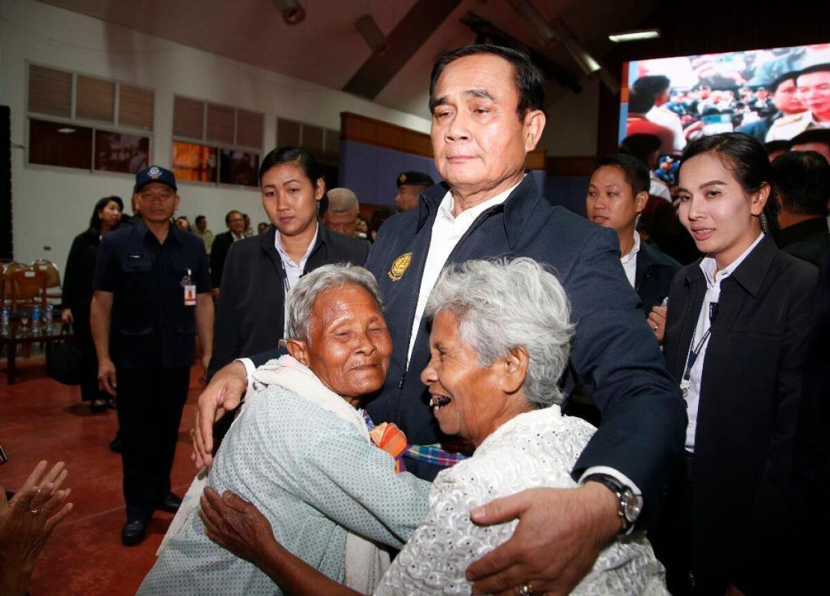 Thai women hug Prime Minister Prayuth Chan-ocha at a campaign event in Nakhon Ratchasima, Thailand, on March 13.