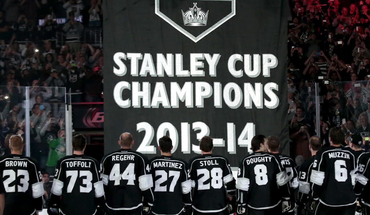 Kings players watch as the NHL championship banner is raised to the rafters at Staples Center on Wednesday night.