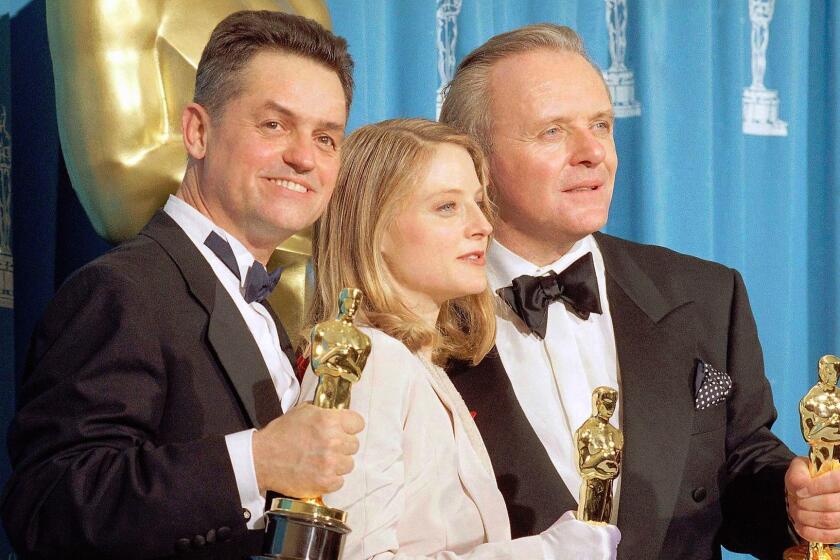 FILE - In this May 31, 1992 file photo, director Jonathan Demme, left, holds his award for best director, actress Jodie Foster holds her award for best actress, and actor Anthony Hopkins holds his award for best actor for their work on "Silence of the Lambs," at the Academy Awards in Los Angeles. Demme died, Wednesday, April 26, 2017, from complications from esophageal cancer in New York. He was 73. (AP Photo/Reed Saxon, File)