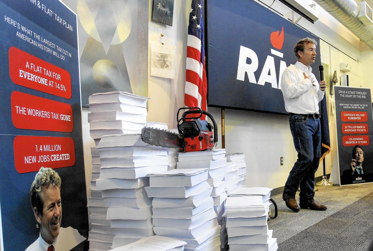 Kentucky Sen. Rand Paul, who is running for the GOP's presidential nomination, has circulated a video showing him taking a chain saw to a stack of tax-code books.