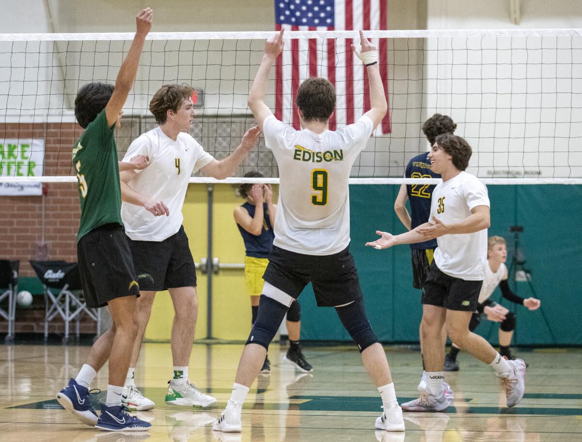 Edison's Zane Ching, left, Beau Johnson, Owen Shaff and Johnny Braunstein, right, celebrate a point against Marina.
