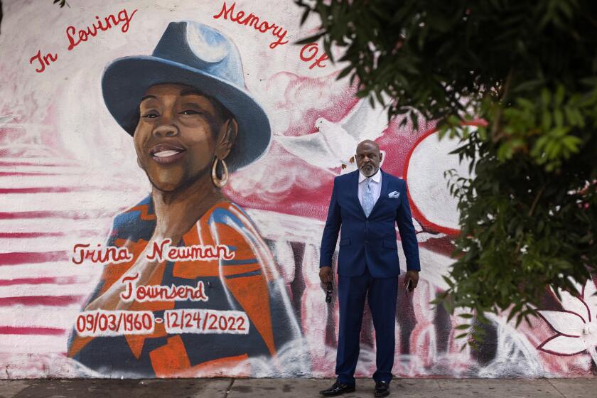 Los Angeles, CA - September 18: Curtis A. Townsend Sr., husband of Trina Newman, a retired minister, mother and grandmother, gathers at a mural in honor of his late wife near the location where she was killed by a speeding driver in South Central on Monday, Sept. 18, 2023 in Los Angeles, CA. (Jason Armond / Los Angeles Times)