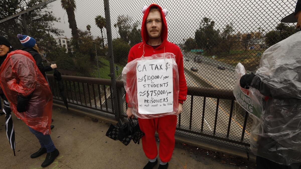 Johnathan Hass, a teacher at LeConte Middle School, states his case while picketing with United Teachers Los Angeles along Sunset Boulevard above the 101 Freeway as part of the "Sunset Boulevard Gauntlet."